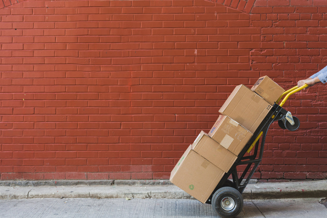 A man standing outside of a food and beverage shop